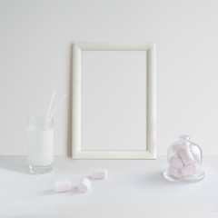 Frame Mock Up with glass of milk and pink marshmallows