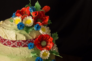 closeup Ukrainian cake with sugar flowers on a black background