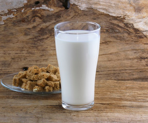 Milk in glass on old wooden floor.