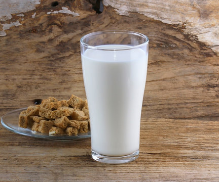Milk in glass on old wooden floor.