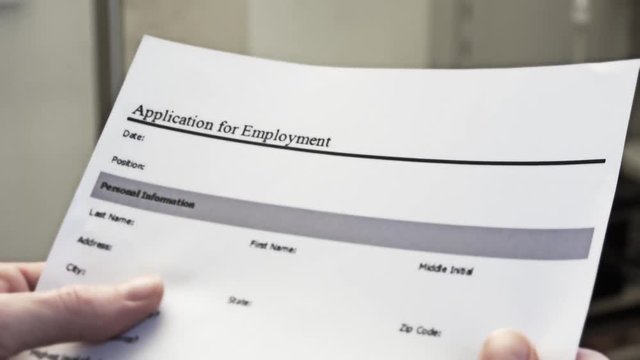 Employment Application Form In Male Hands. An application for employment or job application is a form or collection of forms that an individual seeking employment, called an applicant, must fill out