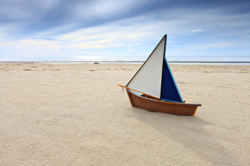 Ship model on summer sunny beach
