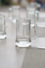 empty glass mug, cutlery and white dish, blur and defocus