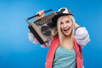 Woman holding retro boom box © Drobot Dean