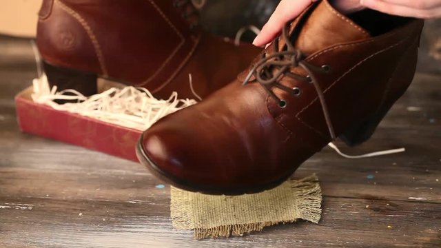 clean boots shoes, female, brown heel, straw box, beautiful style, wooden table hands leather, shine polish,glassazh sponge