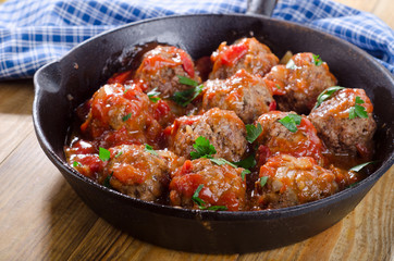 Beef Meatballs with Tomato Sauce on a pan.