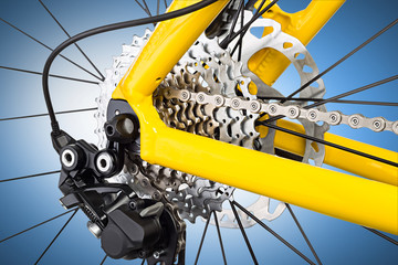 derailleur mechanism on a bicycle on bluebackground / Schaltwerk an einem Fahrrad vor blauem...