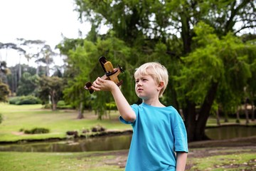 Boy playing with a toy aeroplane