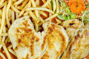 Chicken fillet with fries and salad