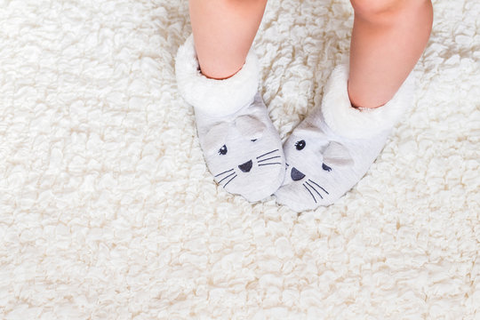 Child's Feet In Slippers