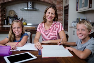 Mother helping kids with their homework