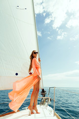 fashion girl yachting in sea with blue sky sunlight