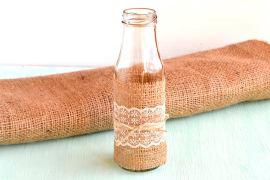 Handmade vase, burlap, wooden background