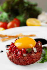 Beef tartare served on a plate, close up