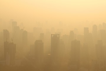 Buildings under construction with cranes in misty morning, Bangkok, Thailand - obrazy, fototapety, plakaty