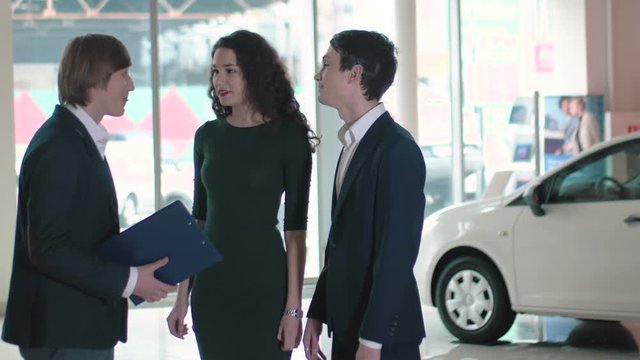 Young couple interested in buying a new car