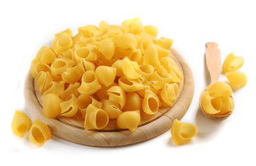 Pile of Italian dry pasta on a wooden board,  isolated on white