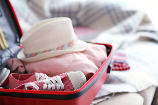 Woman's clothes in a red suitcase, close up