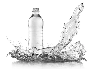Fototapeten Splashing water onto bottle over grey background © Africa Studio