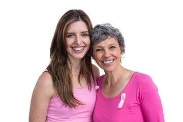 Smiling women in pink outfits posing for breast cancer awareness