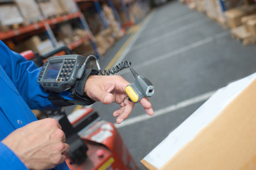 Scanning parcel in warehouse with finger scanner