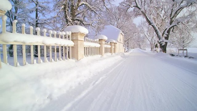 Thick snow on the side of the fence of the manor. The Palmse manor is filled with snow on a winter season