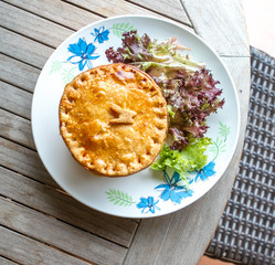Meat pie with salad on the side