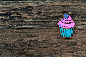 Wooden colored cupcake on wooden background