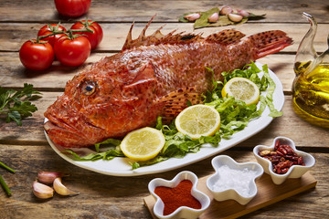 red fish on a background of green lettuce