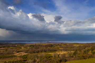 Fototapeta na wymiar Rain-bearing clouds hang over the horizon over Poole Harbour