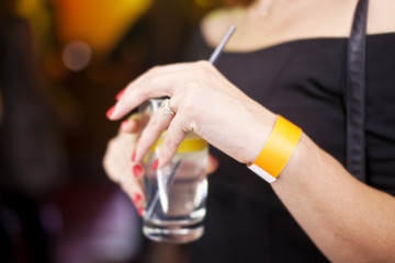 Glass with a drink in the hands of women