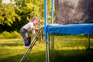 Child on trampoline ladder