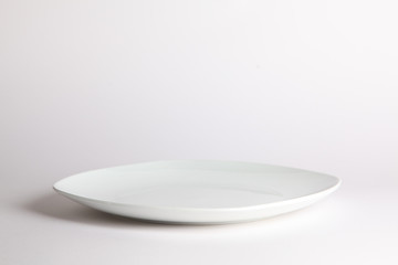 White empty plate on white background
