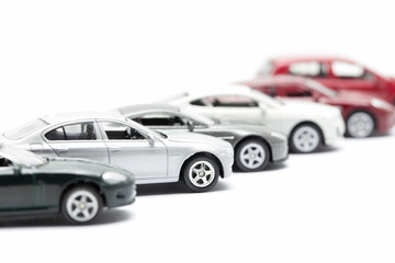 Fototapeta na wymiar toy cars arranged on white background