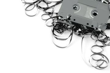 vintage audio cassette with tangled messy tape.