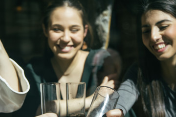 Women laughing and having fun in a bar