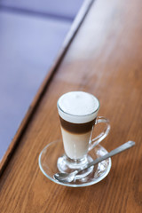 Cafe latte on the white vintage wooden table