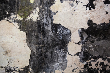 The wall texture with cracked plaster and whitewash