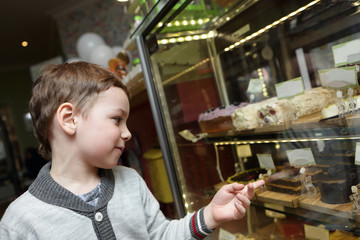 Boy choosing cake