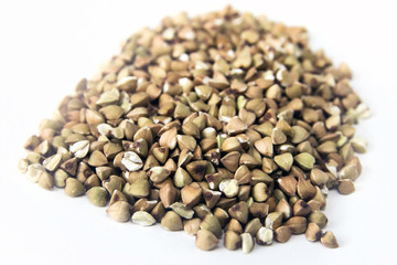 Fototapeta premium handful of green buckwheat closeup isolated
