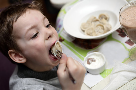 Boy Eating Meat Dumplings