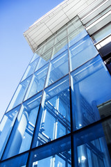 Obraz premium glass-clad facade of a modern building covered in reflective plate glass