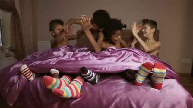 Boys play hand-clapping game.