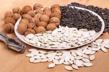 Walnuts, sunflower and pumpkin seeds on a plate.