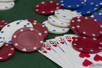 Poker chips and cards on a green table
