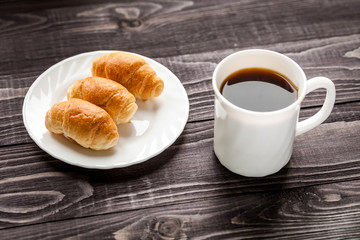 small croissants and cup of coffee