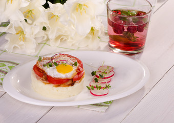 Mashed potatoes with fried eggs, radish and raspberry drink.