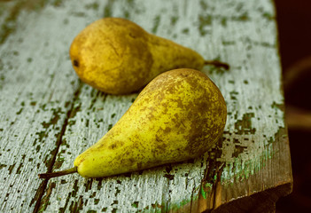 Two pears on wooden background