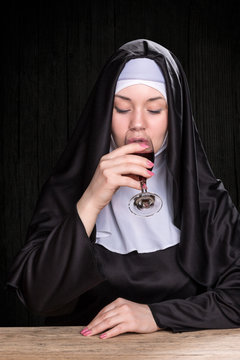 Nun Drinking Wine