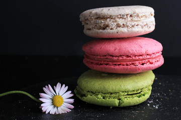 Macarons on black background. Sweets, desserts wallpaper